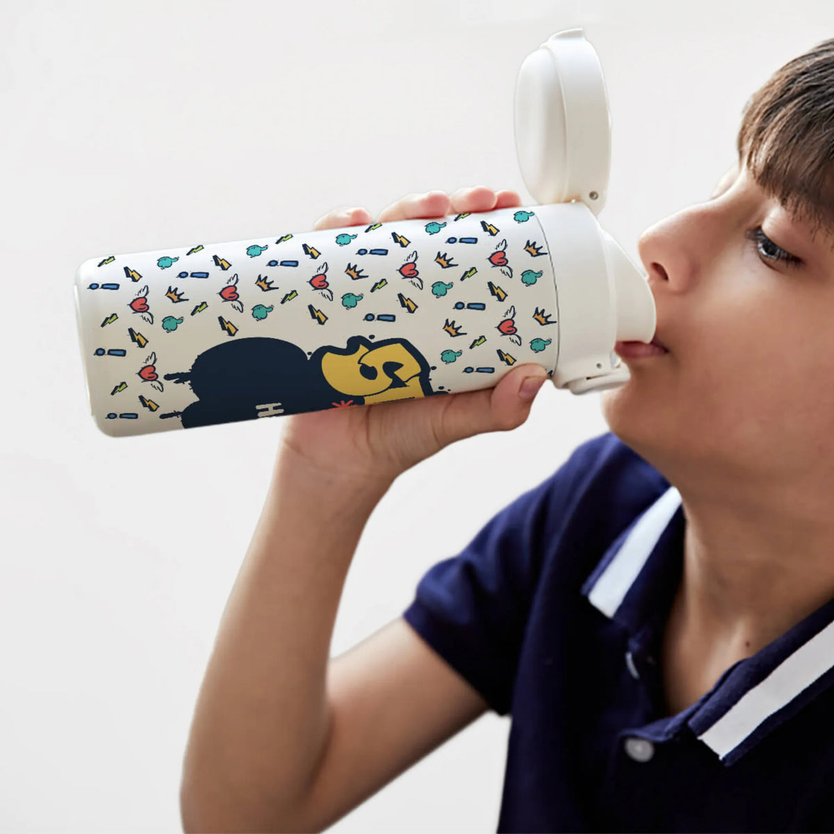 A child drinking from a personalized, leakproof, bpa free, steel, insulated water bottle.