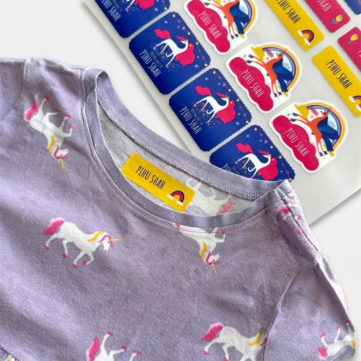iron on labels with rainbow and unicorn design. het transferred on a kids dress